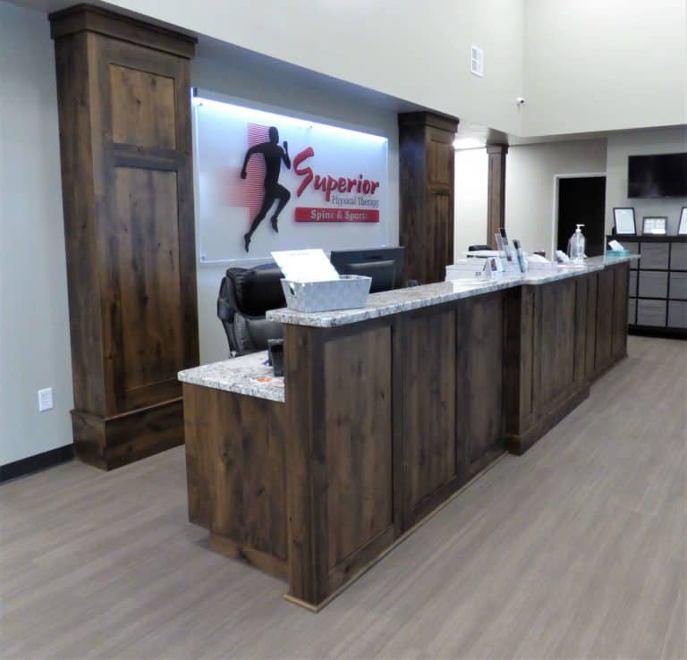 Custom Dark Front Desk Cabinetry installation at Superior Physical Therapy in Idaho Falls.