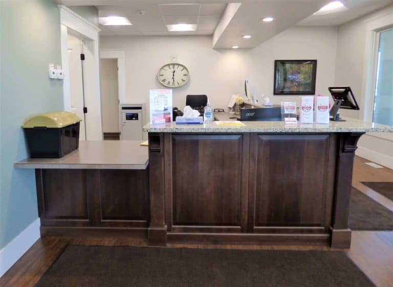 Sideview of the Sterling Urgent Care wooden front desk with custom countertop