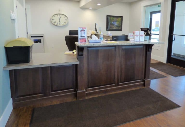 Sideview Sterling Urgent Care wooden front desk with custom countertop