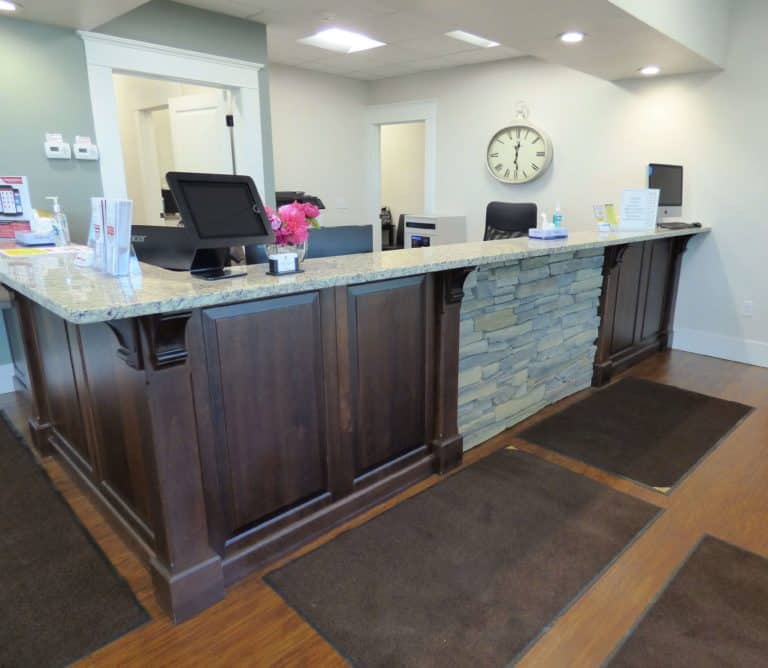 Sterling Urgent Care wooden front desk alternate view with stone details