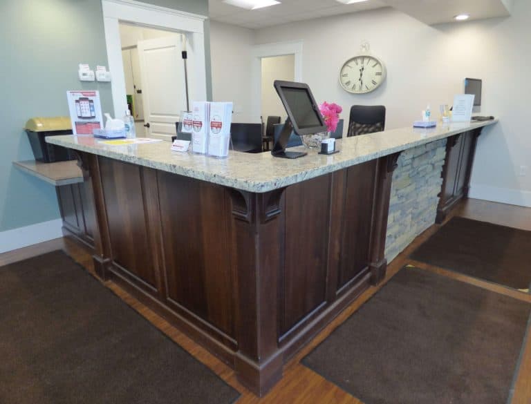Sterling Urgent Care wooden front desk with stone feature and custom countertop installation