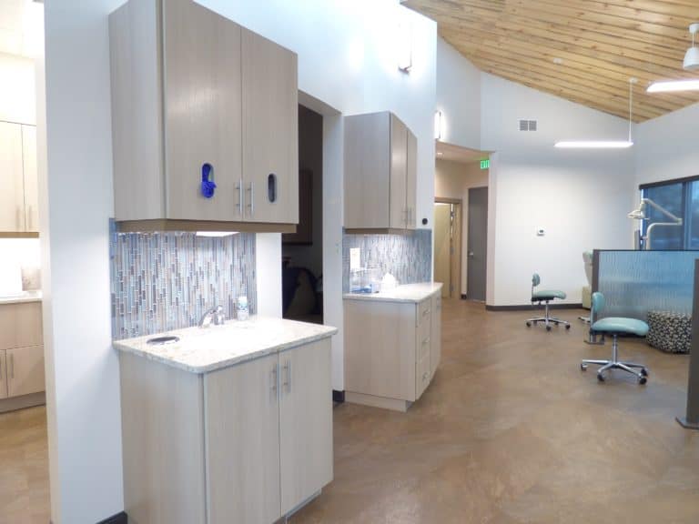 View of the white custom cabinet installation with backsplash at River Valley Orthodontics in Burley Idaho.