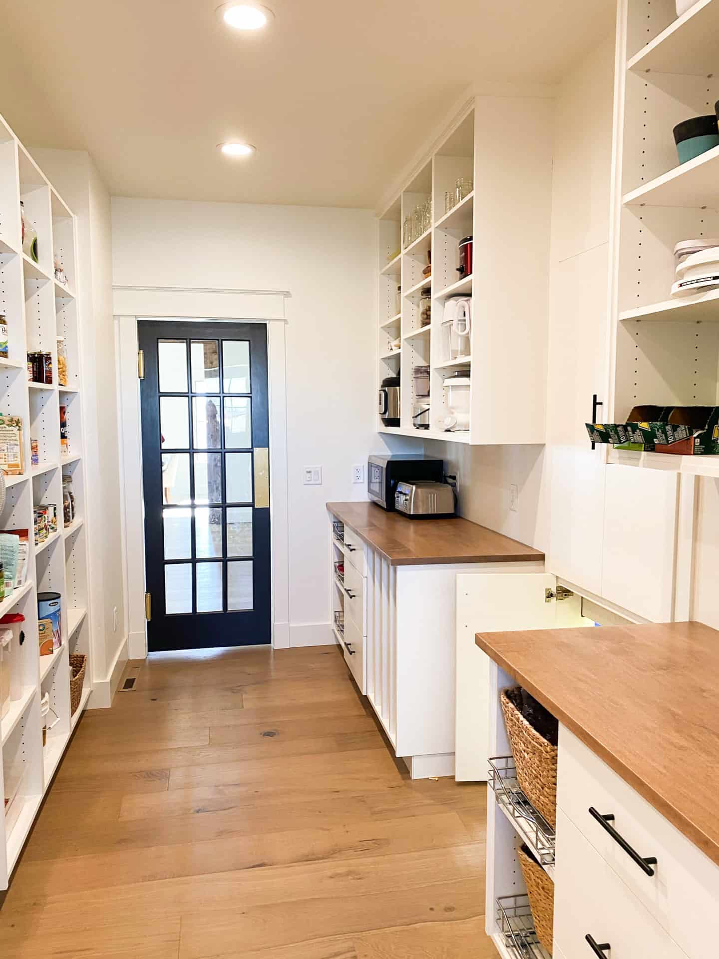 pantry with wooden shelves and cabinets