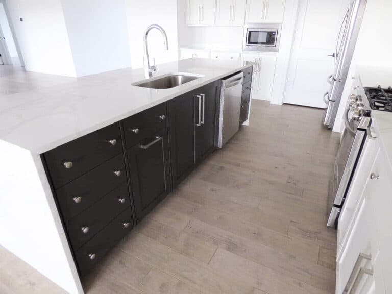 Millennial Cabinetry and Millwork pictured white kitchen with black drawers