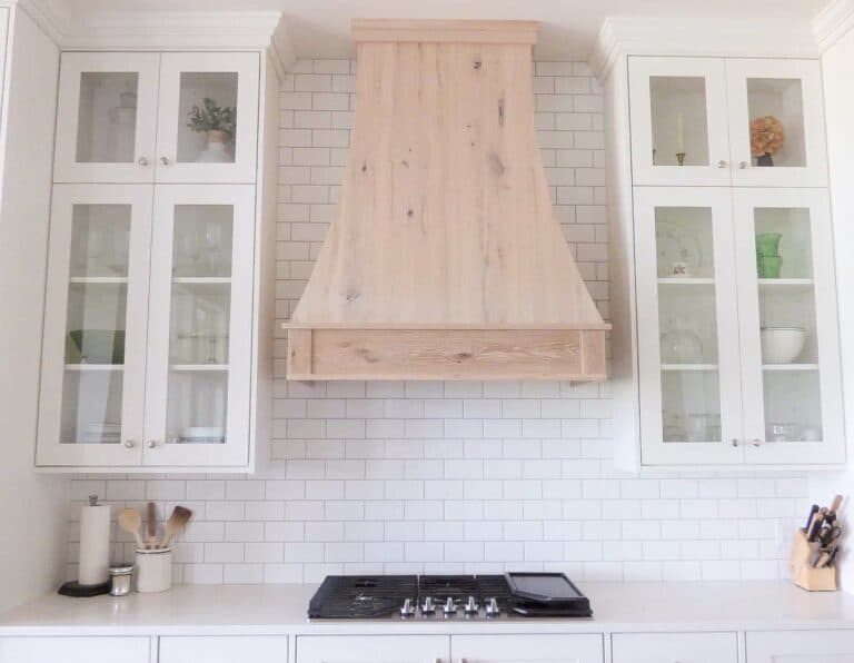 white custom kitchen cabinets with natural finish range hood
